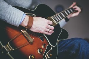 person using guitar